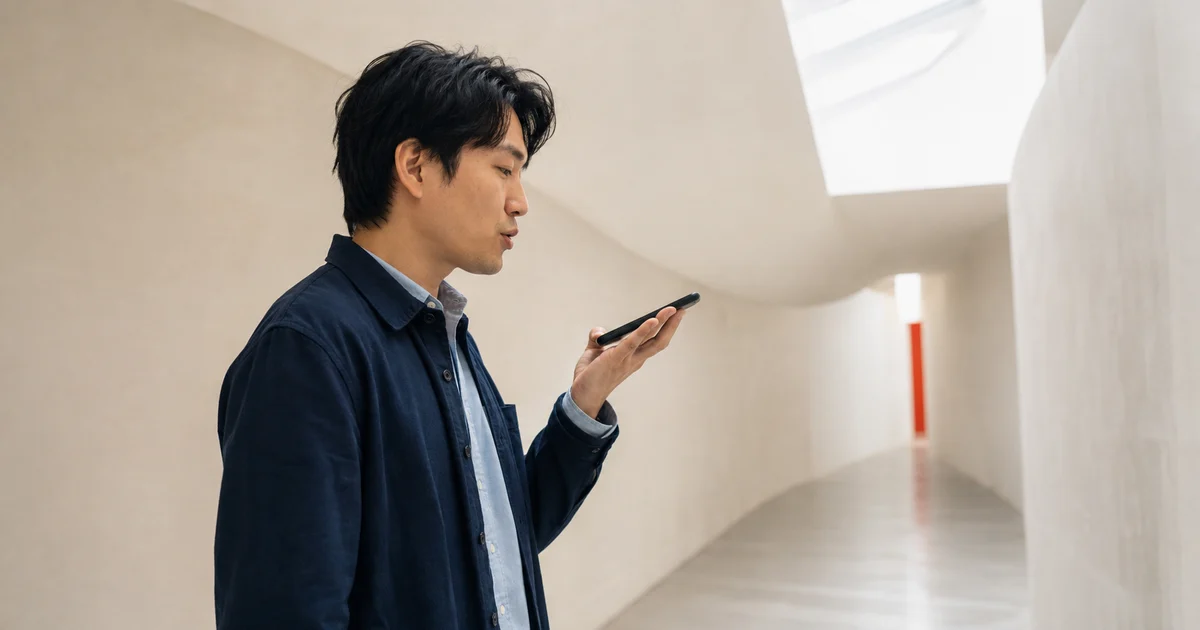 A brand strategist testing a voice search question on a smartphone