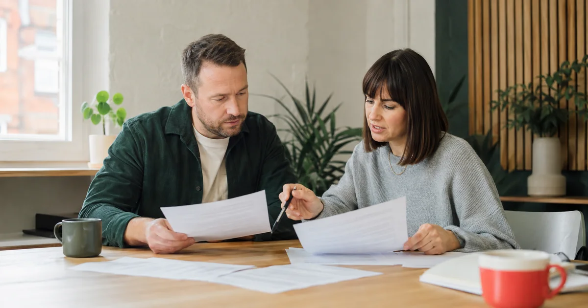 A business owner and Polish language specialist comparing translation samples together